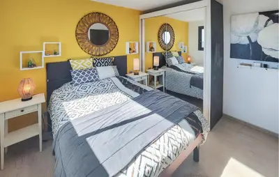 a bedroom with a large bed and a mirror at Cozy Home In La Redorte in La Redorte