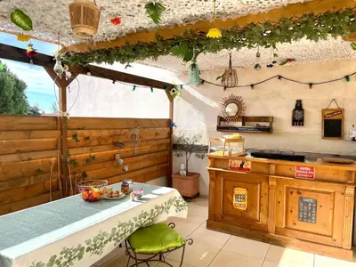 a kitchen with a counter and a table in a room at La Maison Nikaïa in Narbonne