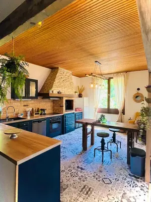 a kitchen with blue cabinets and a wooden ceiling at Maison de vacances familiale 4 chambres in Quillan