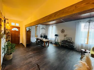 a living room with yellow walls and wooden floors at Maison de vacances familiale 4 chambres in Quillan