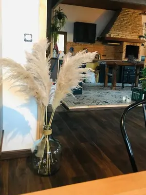 a vase with feathers in it sitting on a table at Maison de vacances familiale 4 chambres in Quillan