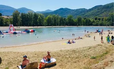 a group of people on a beach in the water at Maison de vacances familiale 4 chambres in Quillan