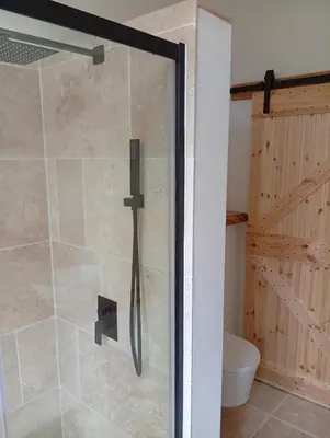 a shower with a glass door in a bathroom at Maison de vacances familiale 4 chambres in Quillan