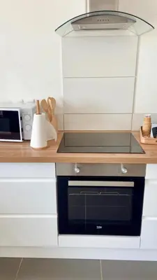 a kitchen with a microwave and a stove top oven at Appartement Malibu in Lapalme