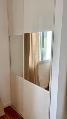 a large white cabinet with a mirror in a room at Appartement Malibu in Lapalme