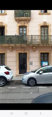 two cars parked in a parking lot in front of a building at Studio Robine les halles avec clim in Narbonne