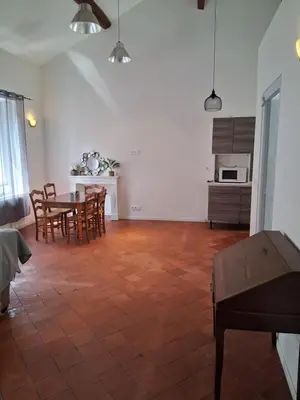 a kitchen and dining room with a table and chairs at Chez Sylvie in Carcassonne