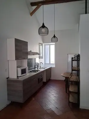 a kitchen with a microwave and a table in it at Chez Sylvie in Carcassonne