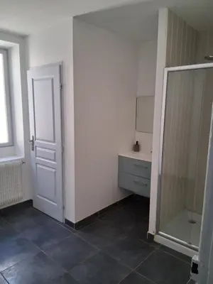 a bathroom with a mirror and a white door at Chez Sylvie in Carcassonne