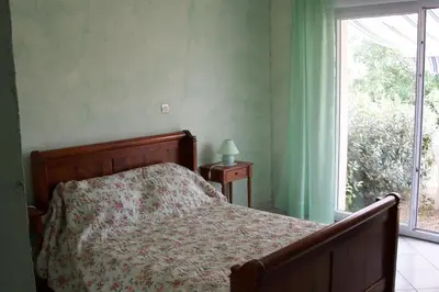 a bedroom with a bed and a window at Le Fenouillet Chambres D'hotes proche des Grands Buffets in Narbonne