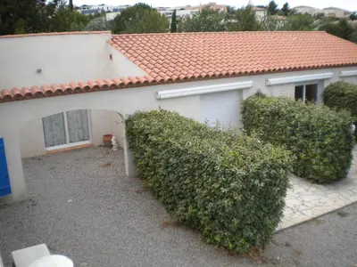 a white house with bushes in front of it at Le Fenouillet Chambres D'hotes proche des Grands Buffets in Narbonne