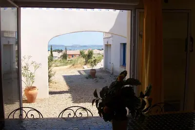 an open door to a patio with a potted plant at Le Fenouillet Chambres D'hotes proche des Grands Buffets in Narbonne