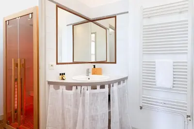 a bathroom with a sink and a mirror at L'instant Voltaire in Carcassonne