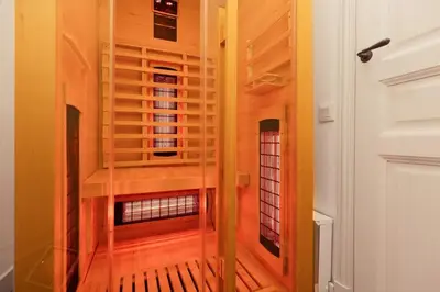 a room with wooden floors and a glass door at L'instant Voltaire in Carcassonne