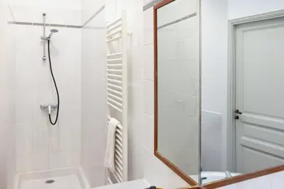 a bathroom with a shower and a mirror at L'instant Voltaire in Carcassonne