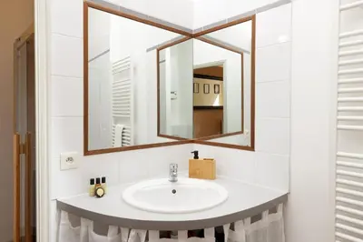 a bathroom with a sink and a mirror at L'instant Voltaire in Carcassonne