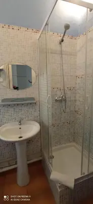 a bedroom with a bed and a table and windows at Hôtel de Paris - Narbonne in Narbonne