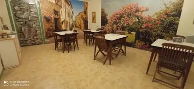 a bedroom with a white bed and a red chair at Hôtel de Paris - Narbonne in Narbonne