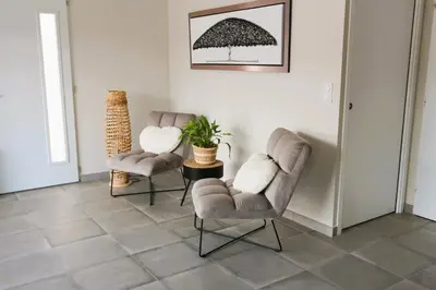 two chairs and a table in a living room at Maison T3 in Sallèles-dʼAude