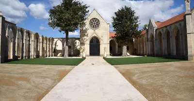 a building with a church with a clock on it at Maison T3 in Sallèles-dʼAude