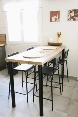 a dining room table with black chairs around it at Maison T3 in Sallèles-dʼAude