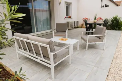 a patio with two chairs and a table on a patio at Maison T3 in Sallèles-dʼAude