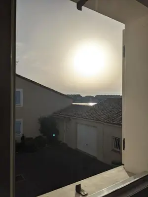 a view from a window of a house with the sunset at Maison de vacances climatisée 600m de la mer Cour privative et parking in Port-la-Nouvelle