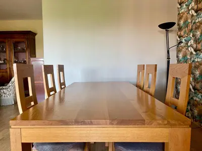a wooden table with four chairs and a wooden table at Le Vintage des Oliviers - Vue Aude ascenseur et parking in Carcassonne