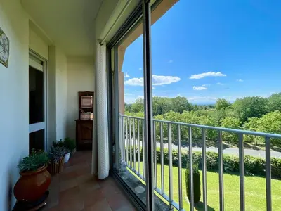 a balcony with a large glass door with a view at Le Vintage des Oliviers - Vue Aude ascenseur et parking in Carcassonne