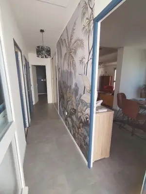 a hallway with a wall with a mural of plants at Lumineuse villa au pied de la pinède in Lézignan-Corbières
