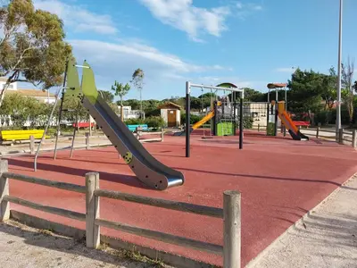 a playground with a slide in a park at La Maison de la Plage in Port-la-Nouvelle