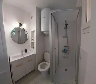 a bathroom with a toilet and a sink and a shower at La Maison de la Plage in Port-la-Nouvelle