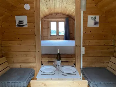 a room with a table and a bed in a cabin at Échappée Vigneronne in Pennautier