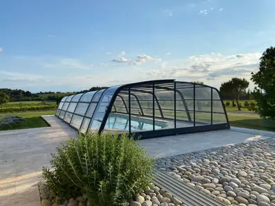 a glass house with a swimming pool in it at Échappée Vigneronne in Pennautier