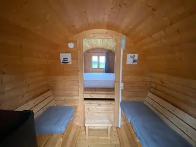 a wooden sauna with two beds and a window at Échappée Vigneronne in Pennautier