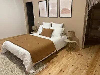 a bedroom with a bed with white sheets and pillows at Villa de charme avec spa in Pamiers
