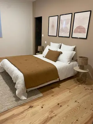 a bedroom with a large bed with white pillows at Villa de charme avec spa in Pamiers