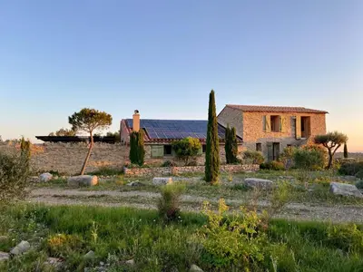 a house in the middle of a field with trees at Bergerie bonheur! in Port-la-Nouvelle