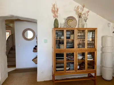 a room with a wooden cabinet with dishes on it at Bergerie bonheur! in Port-la-Nouvelle