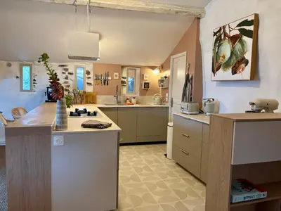 a large kitchen with a large island in a room at Bergerie bonheur! in Port-la-Nouvelle