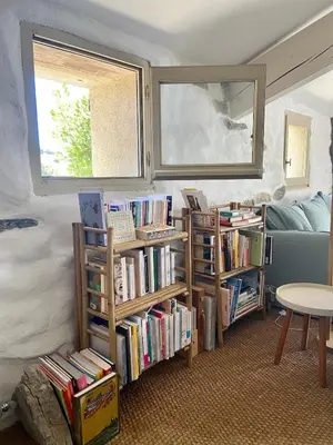 a room with book shelves filled with books at Bergerie bonheur! in Port-la-Nouvelle