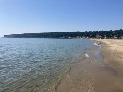 a view of a beach with the sand and water at La franqui , nouveau , Duplex pour 2 ou 3 ,piscine, mer ,soleil , station familiale in La Franqui-Plage