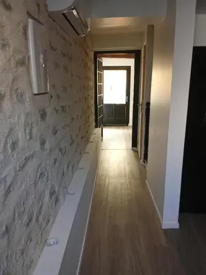 a hallway of a room with a bath tub at La Céliane- climatisé avec patio classé 3 étoiles in Castelnaudary