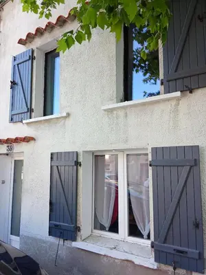 a building with doors and windows on it at La Céliane- climatisé avec patio classé 3 étoiles in Castelnaudary
