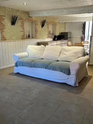 a large white bed sitting in a room at Maison loft au cachet ancien in Villasavary