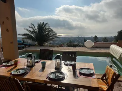 a wooden table with plates and glasses on top of a pool at Villa Hoi An in Fitou