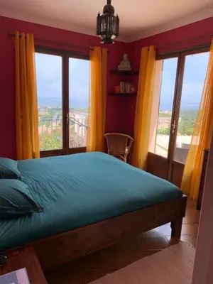 a bedroom with a bed and a large window at Villa Hoi An in Fitou
