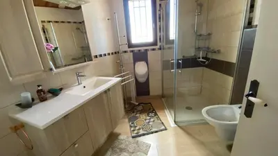 a bathroom with a sink and a shower and a toilet at Villa Hoi An in Fitou
