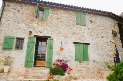 an old stone house with green shuttered windows at Volet verts 8 personnes in Fitou