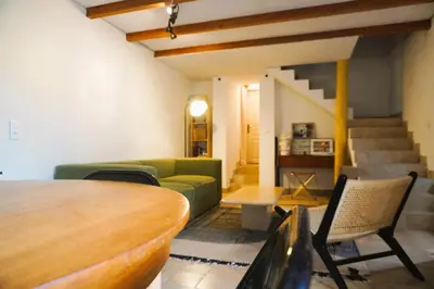 a living room with a green couch and a table at Volet verts 8 personnes in Fitou